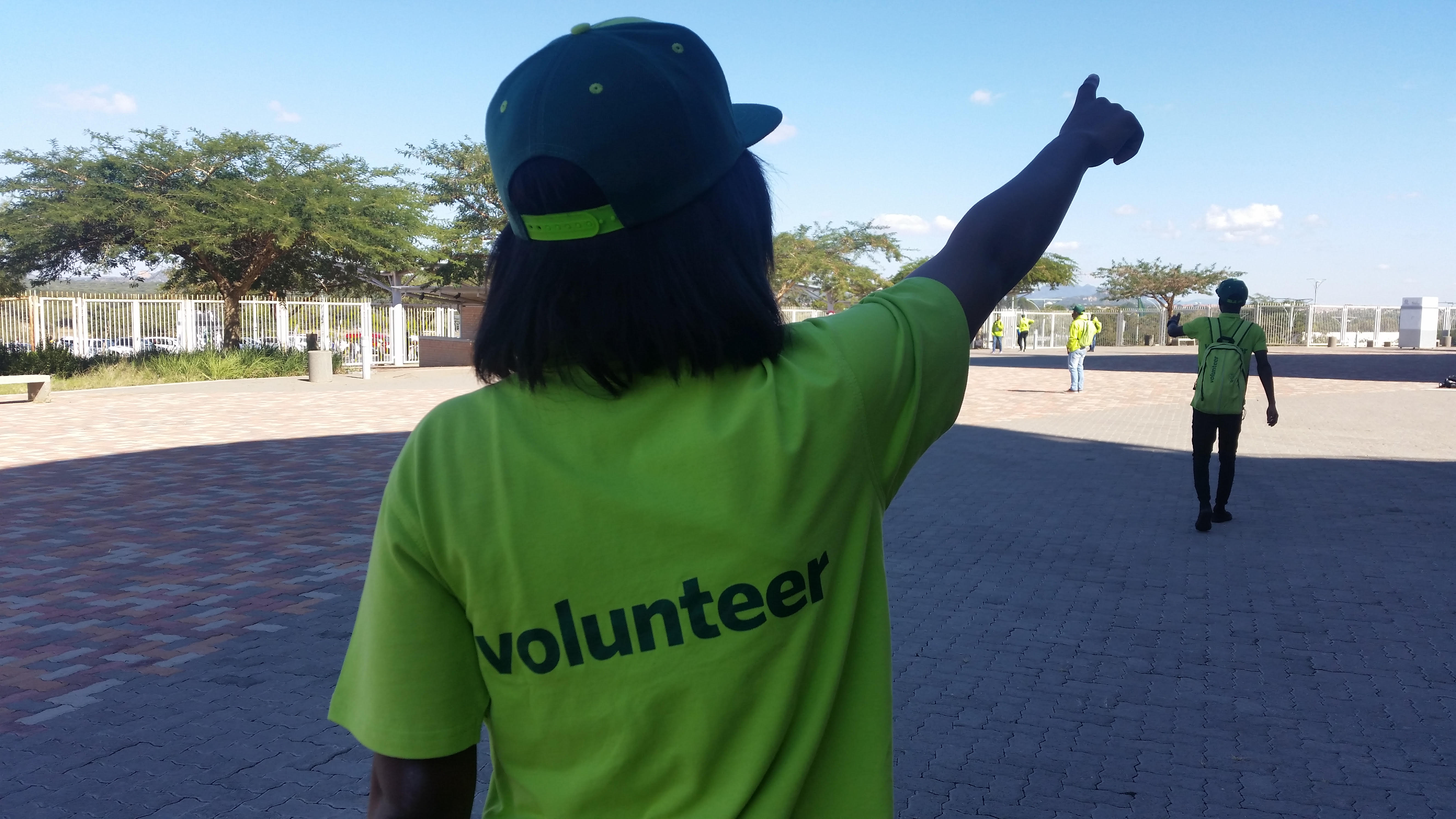A Volunteer showing spectators where to go.. A Volunteer showing spectators where to go..